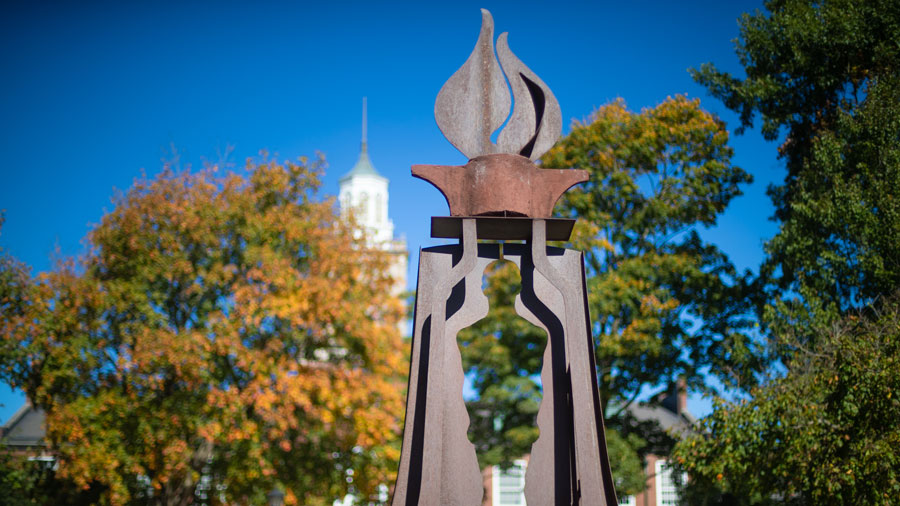 Gateway statue outside Browning that shows a human silhouette underneath a flame. 