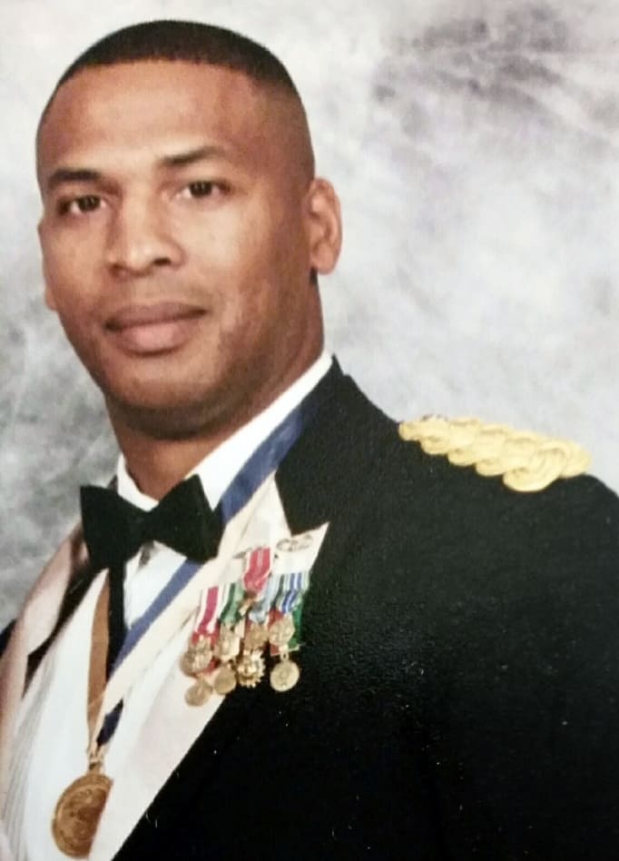 Portrait of a Brian Vaughn in a formal military uniform with medals and a bow tie